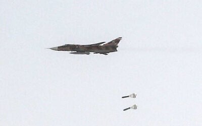 This handout picture released by Iran’s Army office on July 24, 2023, shows an Islamic Republic of Iran Air Force Sukhoi Su-24 tactical bomber aircraft releasing bombs during the Fadayeeyan Hareem Velayat aerial exercise in Iran. (Iranian Army office/AFP)