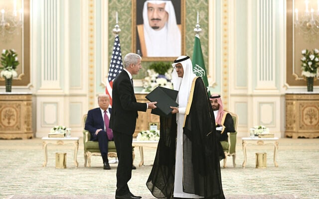 US Secretary of Energy Chris Wright (C-L) and Saudi Arabia’s Energy Minister Prince Abdulaziz bin Salman (C-R) exchange folders as US President Donald Trump (L) and Saudi Arabia’s Crown Prince Mohammed bin Salman (R) look on during a bilateral meeting in Riyadh on May 13, 2025. (Brendan SMIALOWSKI/AFP)