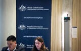 Officials can be seen outside the venue of the Royal Commission on Antisemitism and Social Cohesion in Sydney on May 25, 2026. (DAVID GRAY/AFP)