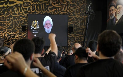 People react as Hezbollah Secretary-General Sheikh Naim Qassem addresses crowds via a screen during the first day of Ashura commemorations at the mausoleum of former Hezbollah leader Hassan Nasrallah in Beirut’s southern suburbs on June 17, 2026. (Anwar Amro/AFP) People react as Hezbollah Secretary-General Sheikh Naim Qassem addresses crowds via a screen during the first day of Ashura commemorations at the mausoleum of former Hezbollah leader Hassan Nasrallah in Beirut’s southern suburbs on June 17, 2026. (Anwar Amro/AFP)