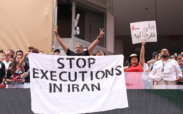 Fans holds the banner reading ‘Stop Executions in Iran’ before the FIFA World Cup 2026 Group G match between Belgium and Iran at Los Angeles Stadium on June 21, 2026 in Inglewood, California. (Stu Forster/Getty Images/AFP)
