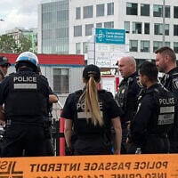 Illustrative: Police gather near the scene of a crime in Montreal on June 22, 2026. (Daphné LEMELIN/AFP)