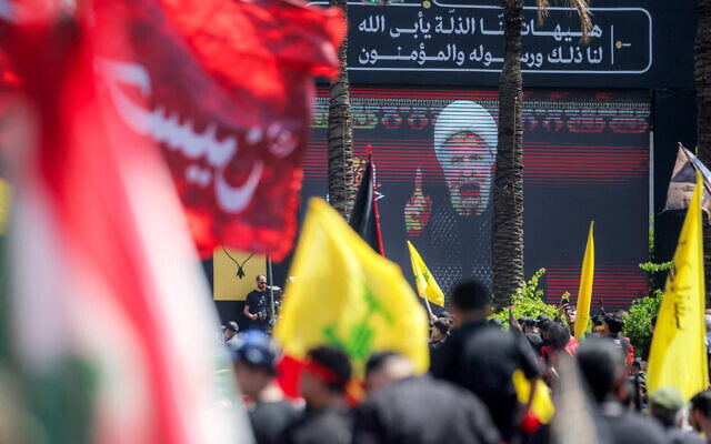 A crowd of Shia Muslim devotees watches a televised speech by Hezbollah leader Naim Qassem on June 26, 2026. (Ibrahim AMRO/AFP)