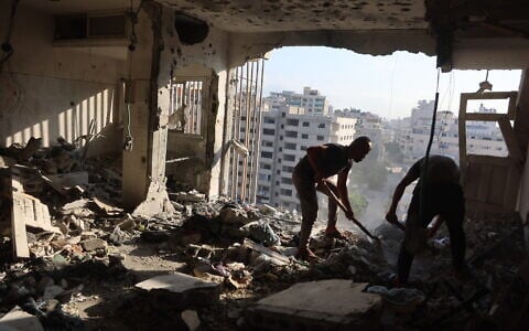 Palestinian residential salvage what they can from an apartment targeted in overnight Israeli airstrikes in Gaza City on August 2, 2026. (Omar AL-QATTAA/AFP)