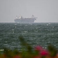 A vessel is seen off the coast of Sharjah in the United Arab Emirates on August 3, 2026. (AFP)