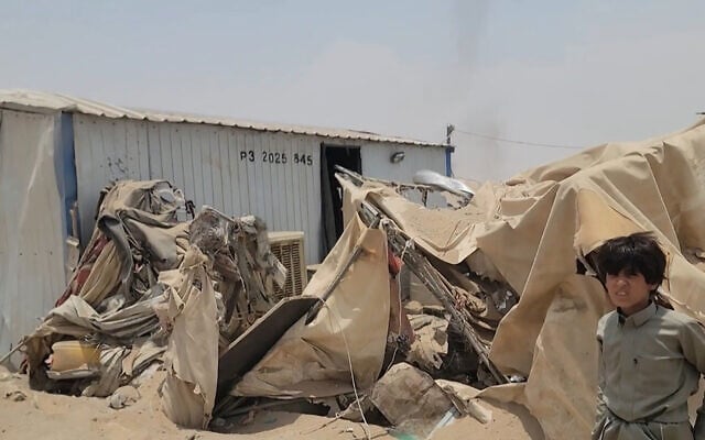 This frame grab taken from AFPTV video footage on August 7, 2026, shows a boy standing near the damage at Mail al-Saila internally displaced camp (IDP) on the outskirts of Marib following a reported Houthi ballistic missile attack on the government-held city of Marib early August 7, amid an escalation in hostilities. (AFPTV/AFP)