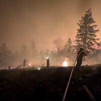 This handout photo taken on August 7, 2026, and released on August 8 by the BC Wildlife Service shows firefighters battling the Bald Range wildfire near Summerland in Canada’s western British Columbia province. (Handout/BC Wildfire Service/AFP)