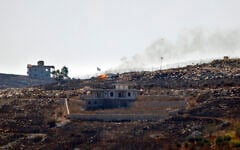 A photograph taken from the southern Lebanese village of Chaqra shows an Israeli flag fluttering over the burnt fields of the border village of Mais al-Jabal, burnt during Israeli military operations on August 11, 2026. (Ammar Ammar/AFP)