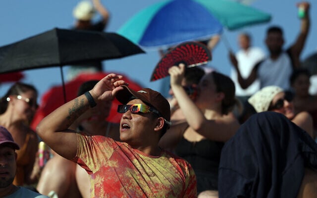 People gather in El Cerro del Tio Pio park in Madrid to observe the total solar eclipse, on August 12, 2026. (Pierre-Philippe Marcou/AFP)
