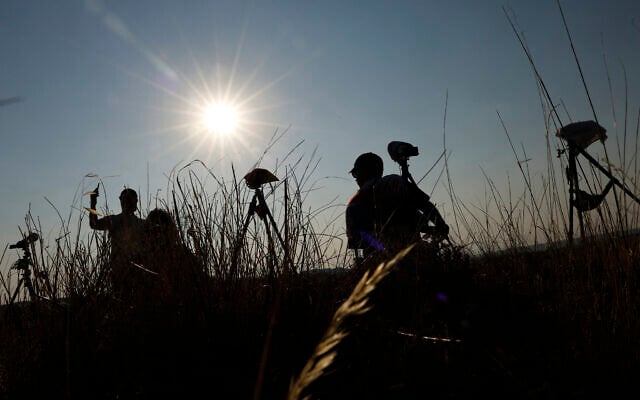 Astronomy enthusiasts make their final adjustments in the hours leading up to the total solar eclipse observation in Berlanga de Duero, 240 km north-east of Madrid, on August 12, 2026. (Oscar DEL POZO/AFP)