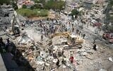 Heavy machinery, first aid responders and residents search the site of an Israeli airstrike that targeted a neighborhood in the southern Lebanese village of Deir al-Zahrani on August 15, 2026. (Abbas FAKIH/AFP)