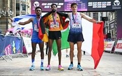 Bronze medalist Israel’s Gashau Ayale, gold medalist Germany’s Amanal Petros and silver medalist Italy’s Pietro Riva celebrate after competing in the men’s marathon during the European Athletics Championships in Birmingham on August 16, 2026. (Paul ELLIS/AFP)