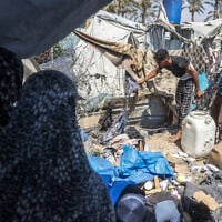 Displaced Palestinians inspect the damage at the site of an alleged Israeli strike on a tent in Khan Yunis, in the southern Gaza Strip, August 16, 2026. (Bashar Taleb/AFP)