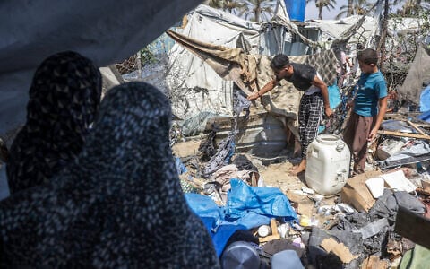 Displaced Palestinians inspect the damage at the site of an alleged Israeli strike on a tent in Khan Yunis, in the southern Gaza Strip, August 16, 2026. (Bashar Taleb/AFP)