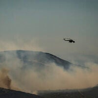 A Mil Mi-8/Mi-17 helicopter flies over a forest during a wildfire on the Greek island of Skyros, in Aegean Sea on August 16, 2026. (Aris MESSINIS/AFP)