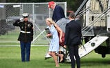 US President Donald Trump and aide Natalie Harp exit Marine One on the Ellipse near the White House on August 16, 2026. (Mandel NGAN/AFP)