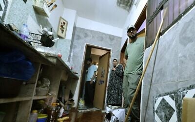 The wife of 58-year-old Fathi Khazem, killed trying to stab a soldier during an arrest operation, stands at the bedroom door with others near a pool of his blood at their home in the northern city of Jenin, in the West Bank on August 21, 2026. (Jaafar Ashtiyeh/AFP) The wife of 58-year-old Fathi Khazem, killed trying to stab a soldier during an arrest operation, stands at the bedroom door with others near a pool of his blood at their home in the northern city of Jenin, in the West Bank on August 21, 2026. (Jaafar Ashtiyeh/AFP)