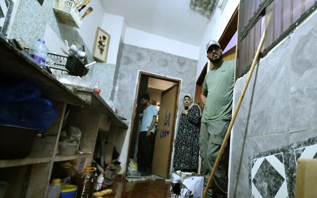 The wife of 58-year-old Fathi Khazem, killed trying to stab a soldier during an arrest operation, stands at the bedroom door with others near a pool of his blood at their home in the northern city of Jenin, in the West Bank on August 21, 2026. (Jaafar Ashtiyeh/AFP) The wife of 58-year-old Fathi Khazem, killed trying to stab a soldier during an arrest operation, stands at the bedroom door with others near a pool of his blood at their home in the northern city of Jenin, in the West Bank on August 21, 2026. (Jaafar Ashtiyeh/AFP)