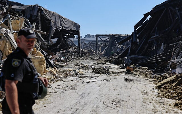 A police officer walks at the site of a shopping mall damaged following a Russian strike in Kryvyi Rih, on August 22, 2026, amid the Russian invasion of Ukraine. (Yan Dobronosov/AFP)
