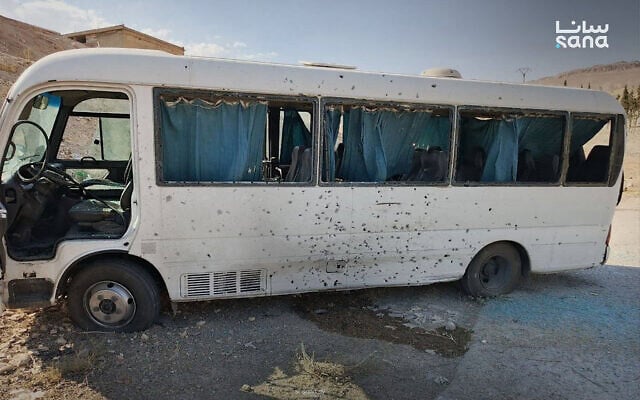 This handout picture released by the Syrian Arab News Agency (SANA) shows a badly damaged bus at the side of a road following a blast in the countryside near the capital Damascus on August 22, 2026. (SANA/AFP)