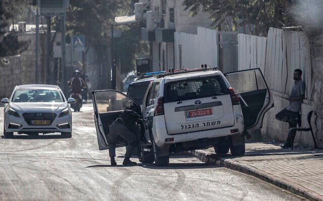 An Israeli police vehicle is parked along the side of a road in Israeli-annexed east Jerusalem’s predominantly Arab neighborhood of Silwan on August 23, 2026. (ilia YEFIMOVICH/AFP)