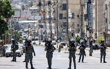 Israeli forces stand guard during a raid on the UNRWA Vocational Training Center, located between the Kafr Aqab neighborhood and the Qalandiya refugee camp, in East Jerusalem, August 25, 2026. (Zain JAAFAR/AFP)