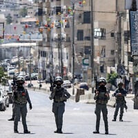 Israeli forces stand guard during a raid on the UNRWA Vocational Training Center, located between the Kafr Aqab neighborhood and the Qalandiya refugee camp, in East Jerusalem, August 25, 2026. (Zain JAAFAR/AFP)