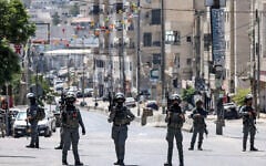 Israeli forces stand guard during a raid on the UNRWA Vocational Training Center, located between the Kafr Aqab neighborhood and the Qalandiya refugee camp, in East Jerusalem, August 25, 2026. (Zain JAAFAR/AFP)