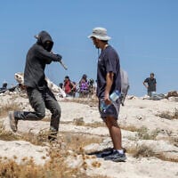 An Israeli settler attacks a left-wing activist at an Israeli outpost in the Palestinian village of Jannatah, just south of the city of Bethlehem on August 25, 2026. (ilia YEFIMOVICH/AFP)