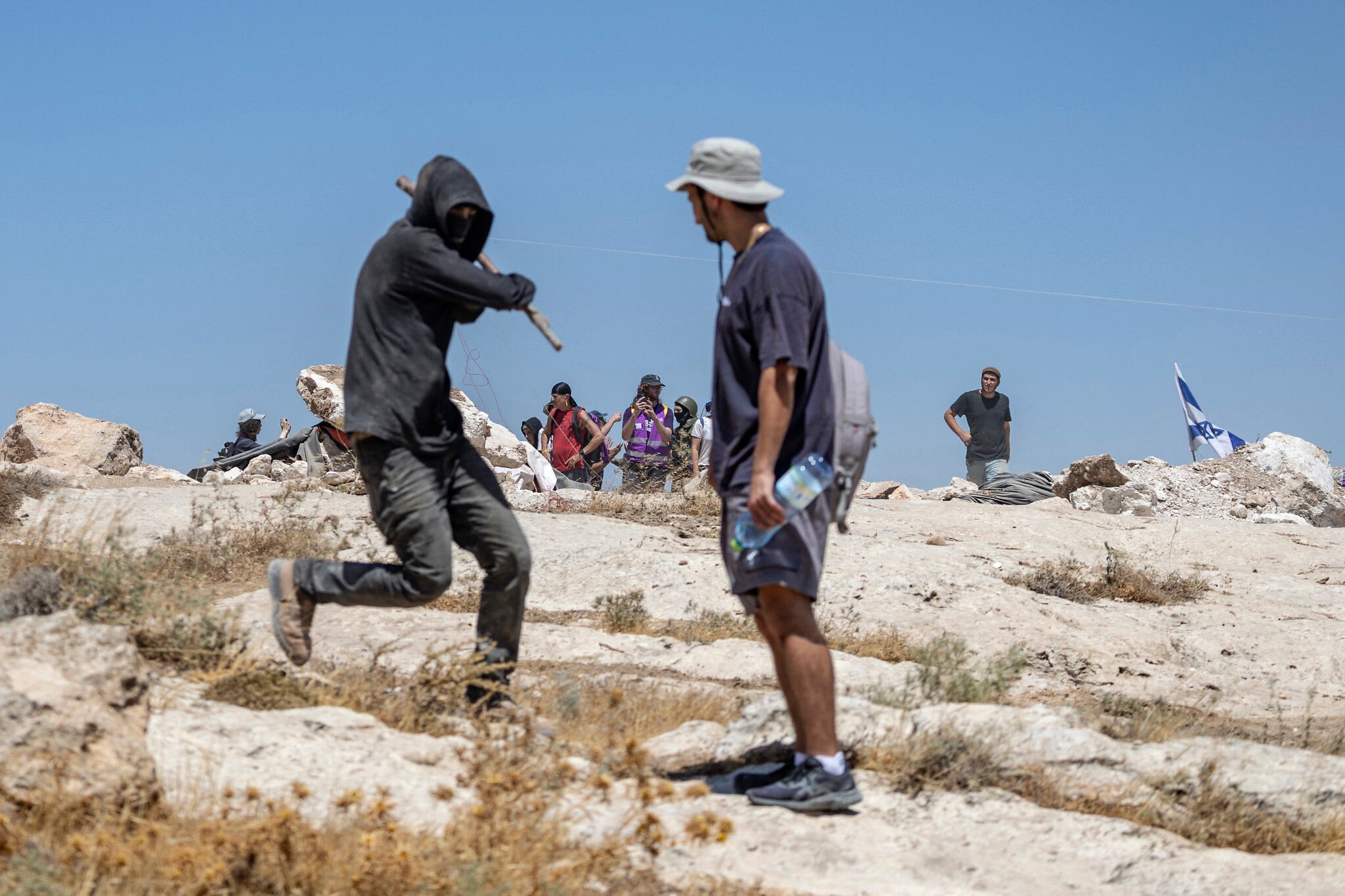 Israeli settlers confront left-wing activists and AFP journalists near the village of Jannatah, south of Bethlehem, August 25, 2026