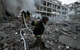 Firefighters work in a destroyed building of a research institute following an attack, which local Russian-installed officials called a Ukrainian strike, in Donetsk, Russian-controlled Ukraine, on August 26, 2026 (AFP)