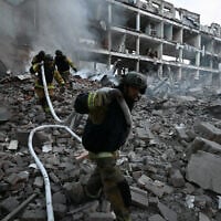 Firefighters work in a destroyed building of a research institute following an attack, which local Russian-installed officials called a Ukrainian strike, in Donetsk, Russian-controlled Ukraine, on August 26, 2026 (AFP)