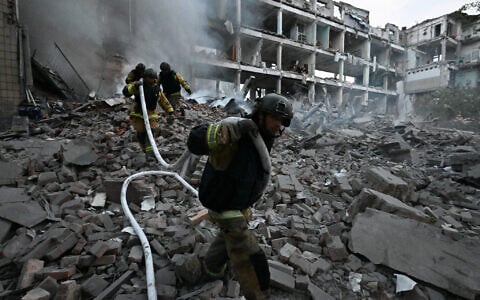 Firefighters work in a destroyed building of a research institute following an attack, which local Russian-installed officials called a Ukrainian strike, in Donetsk, Russian-controlled Ukraine, on August 26, 2026 (AFP)
