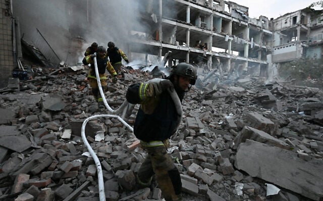 Firefighters work in a destroyed building of a research institute following an attack, which local Russian-installed officials called a Ukrainian strike, in Donetsk, Russian-controlled Ukraine, on August 26, 2026 (AFP)