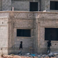 Israeli settlers arrive at a Palestinian home under construction in the village of Qusra, south of the city of Nablus in the West Bank,on August 29, 2026. (Jaafar Ashtiyeh/AFP)