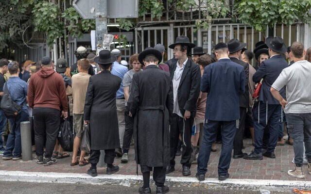 Ultra-Orthodox men outside an Israeli military recruitment centre during a drafting day in Jerusalem on August 30, 2026. (ilia YEFIMOVICH/AFP)