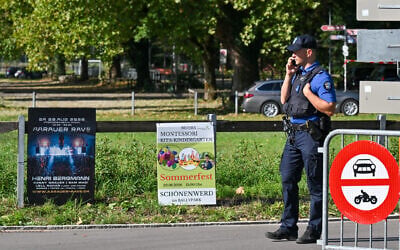 Police officers secure the area next to a poster advertising a rave where a shooting occurred, in Aarau, northern Switzerland, on 30 August 2026. (Harold Cunningham/AFP)