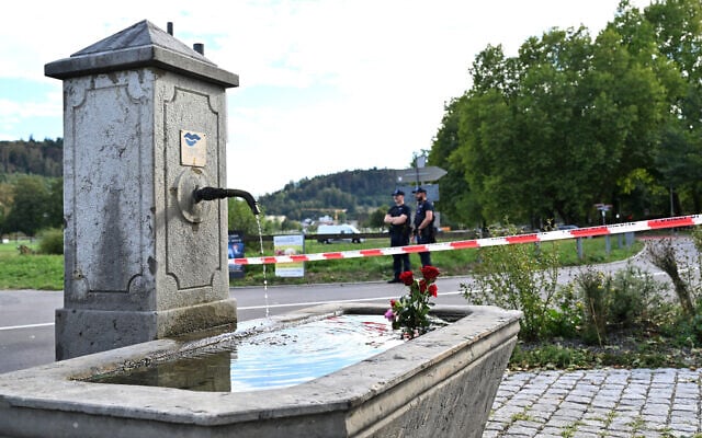 This photograph shows flowers laid in a fountain following a shooting at a rave in Aarau, northern Switzerland, on 30 August 2026. (Harold CUNNINGHAM/AFP)
