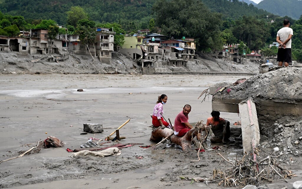 Residents sit beside debris as they salvage belongings following flash floods at Devighat in Nepal’s Nuwakot district on August 31, 2026. (Arun SANKAR/AFP) Residents sit beside debris as they salvage belongings following flash floods at Devighat in Nepal’s Nuwakot district on August 31, 2026. (Arun SANKAR/AFP)