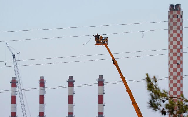 Electricity workers work to fix a power cable at Cyprus's main power station in Mari, Cyprus, July 12, 2011. (AP Photo/Petros Karadjias)