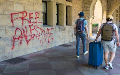 Students walk by graffiti reading "free Palestine" near university president Richard Saller’s office at Stanford University in Palo Alto, California, June 5, 2024. (AP Photo/Nic Coury) Students walk by graffiti reading "free Palestine" near university president Richard Saller’s office at Stanford University in Palo Alto, California, June 5, 2024. (AP Photo/Nic Coury)
