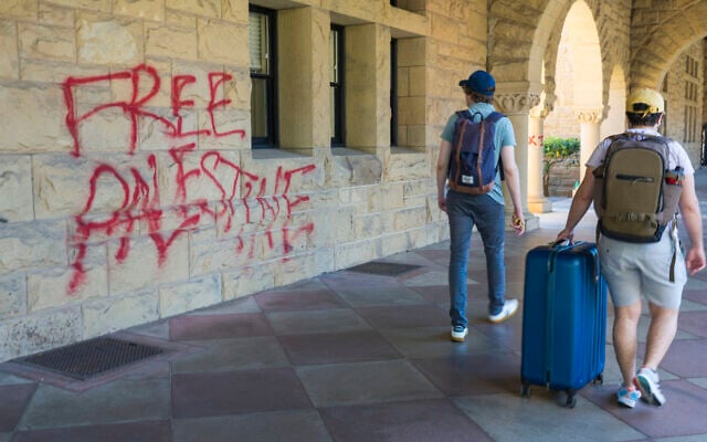 Students walk by graffiti reading "free Palestine" near university president Richard Saller’s office at Stanford University in Palo Alto, California, June 5, 2024. (AP Photo/Nic Coury) Students walk by graffiti reading "free Palestine" near university president Richard Saller’s office at Stanford University in Palo Alto, California, June 5, 2024. (AP Photo/Nic Coury)