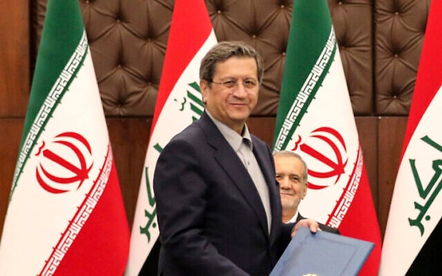 File: Then-Iranian finance minister Abdolnaser Hemmati, with Iranian President Masoud Pezeshkian in the background, at the government palace in Baghdad, Iraq, September 11, 2024. (Ahmed Jalil/Pool Photo via AP)