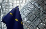 The European Union flag stands inside the atrium at the European Council building in Brussels on June 17, 2024. (AP Photo/Omar Havana)