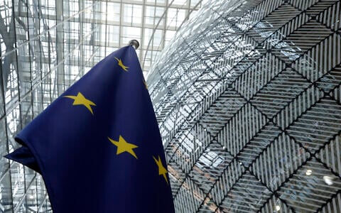 The European Union flag stands inside the atrium at the European Council building in Brussels on June 17, 2024. (AP Photo/Omar Havana)