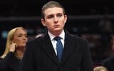Barron Trump watches as his father, US President Donald Trump, attends an indoor Presidential Inauguration parade event at Capital One Arena, in Washington, January 20, 2025. (AP Photo/Evan Vucci)