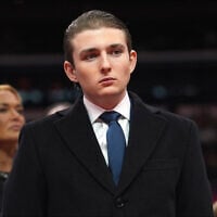 Barron Trump watches as his father, US President Donald Trump, attends an indoor Presidential Inauguration parade event at Capital One Arena, in Washington, January 20, 2025. (AP Photo/Evan Vucci)