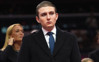 Barron Trump watches as his father, US President Donald Trump, attends an indoor Presidential Inauguration parade event at Capital One Arena, in Washington, January 20, 2025. (AP Photo/Evan Vucci)