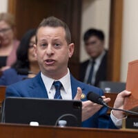 Rep. Jared Moskowitz, D-Fla., holds up a Trump Bible as he questions Attorney General Pam Bondi in the House Judiciary Committee at the Capitol in Washington, February 11, 2026. (AP/J. Scott Applewhite)