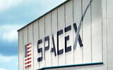 A SpaceX logo is displayed on a building, May 26, 2020, at the Kennedy Space Center in Cape Canaveral, Florida. (AP Photo/David J. Phillip)